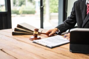 A young businesswoman is working her desk, diligently preparing legal briefs reviewing evidence A young businesswoman is working her desk, diligently preparing legal briefs reviewing evidence
